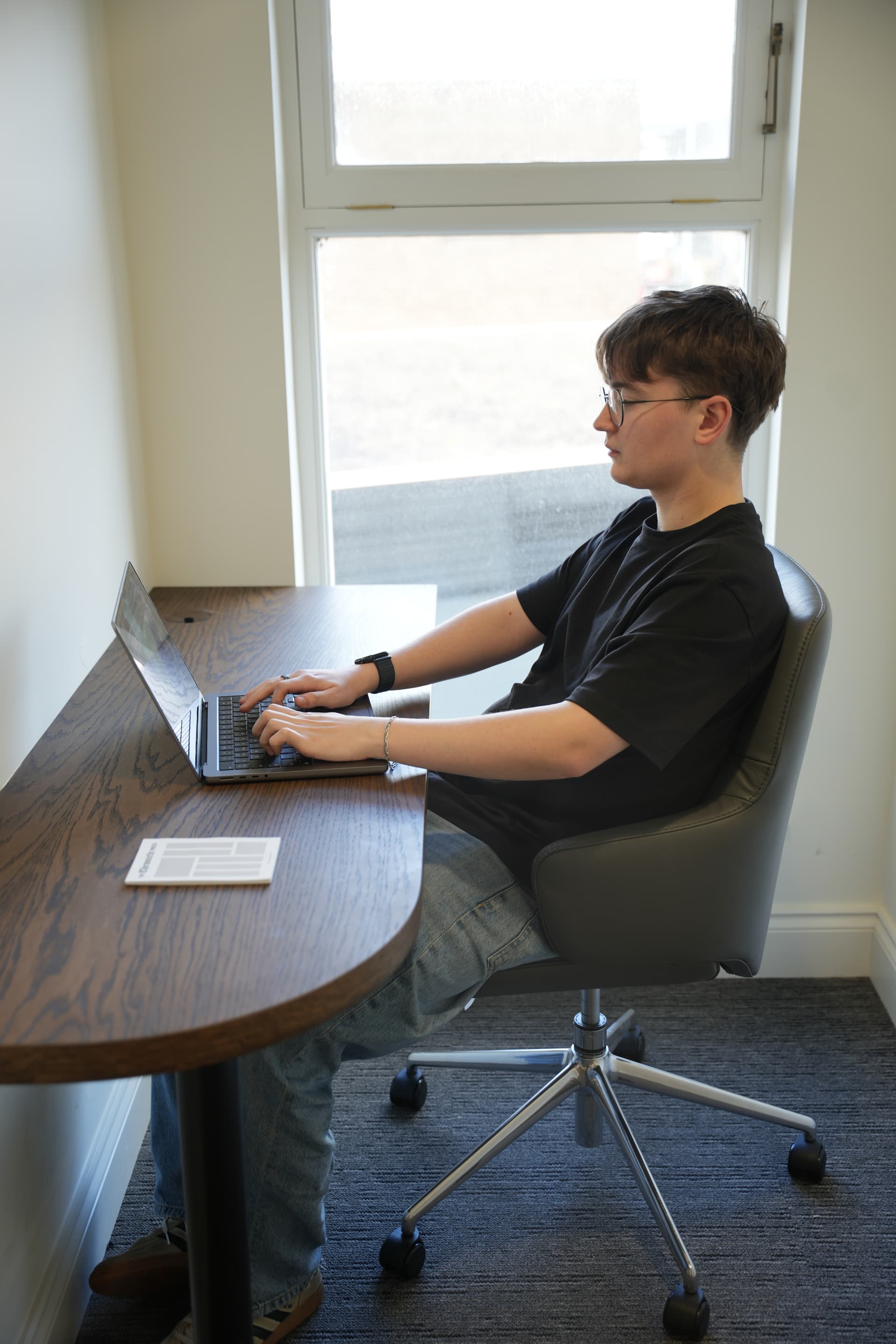 Jamie working at a wooden desk